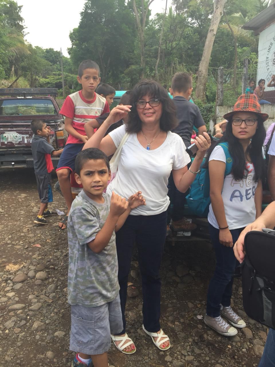 Amalia poses with local children on a dirt road by the INEB school in Las Delicias del Jobo
