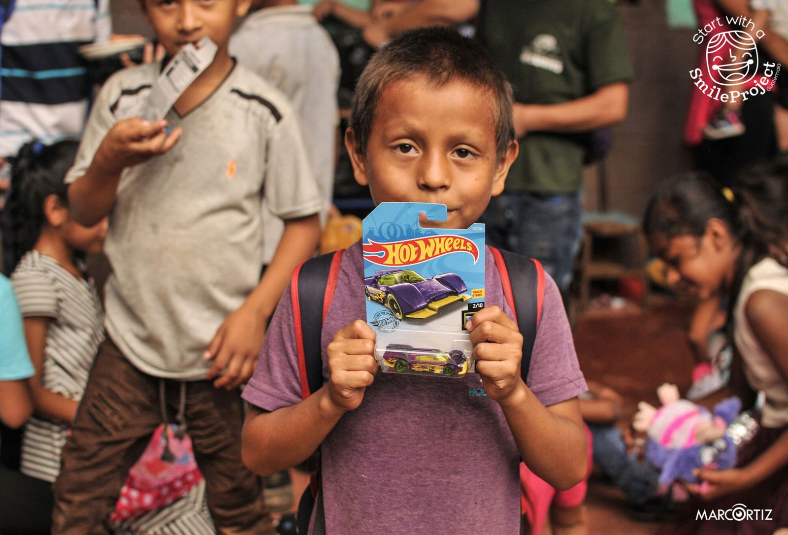 A boy shows off a new Hot Wheels car at the 2019 Children’s Day party in Las Delicias del Jobo